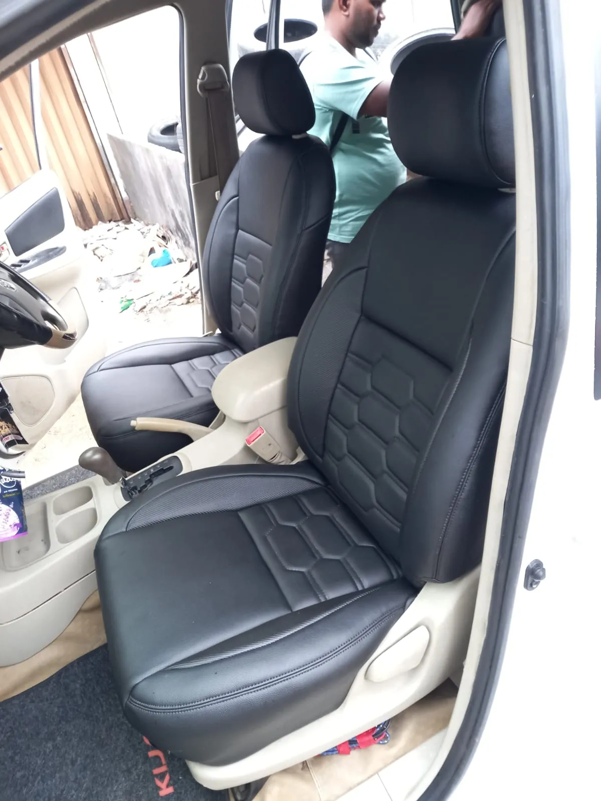 Jok depan mobil hitam dengan jahitan motif heksagon, terpasang di kabin
